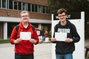 Two students celebrate their GCSE results