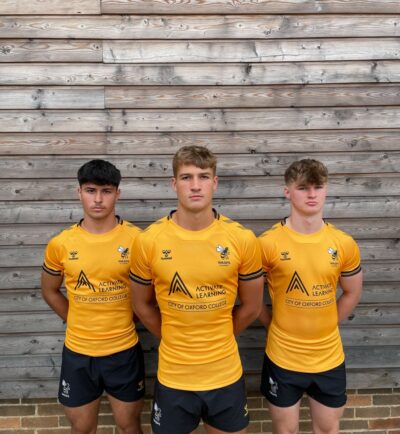 Three boys wearing their rugby kit