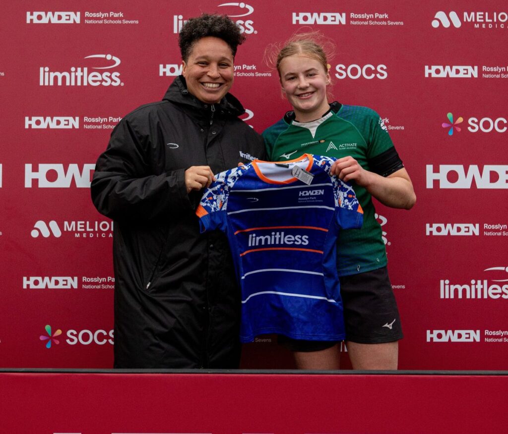 Shaunagh Brown (left) presenting Molly Cann (right) with a commemorative shirt as Limitless Kit's 'Player of the Tournament'.